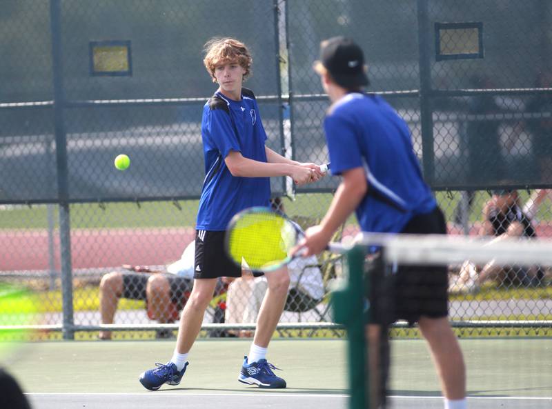 Geneva’s Aaron Masoncup returns the ball during a doubles match with partner Tyler Masoncup (right) in the state championship preliminaries at Buffalo Grove High School on Thursday, May 23, 2024.