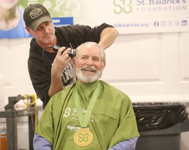 Troy Edwards, owner of Troys Place in Arlington, takes the "first swipe" on Brad Bruins of Peru, during the 18th annual Illinois Valley Emergency Services St. Baldrick's event on Sunday, March 23, 2025 at Senicas Oak Ridge in La Salle. Bruins, raised over $4,000 for St. Baldrick's and collected the most money.