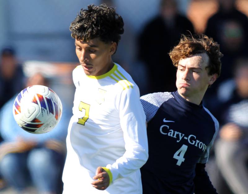 Cary-Grove’s Ethan Ehlebracht, right, and Harvard’s Jesus Aquino race to the ball in IHSA Class 2A Regional Title Game soccer action on Saturday, Oct. 26, 2024, at  Harvard Junior High School  in Harvard.