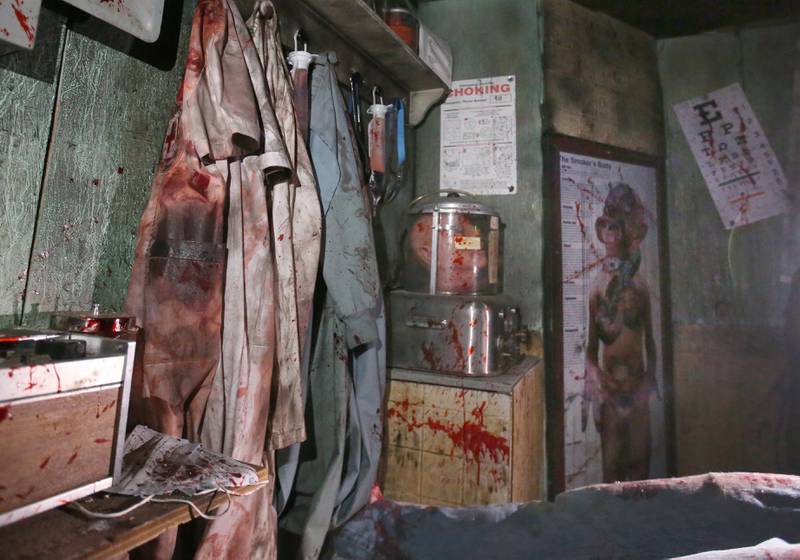 Fake blood stained clothes hang in the mock morgue room  of the Insanity Haunted House on Thusday, Oct. 3, 2024 at the Peru Mall. The haunted house has numerous themed rooms that are full of detai.