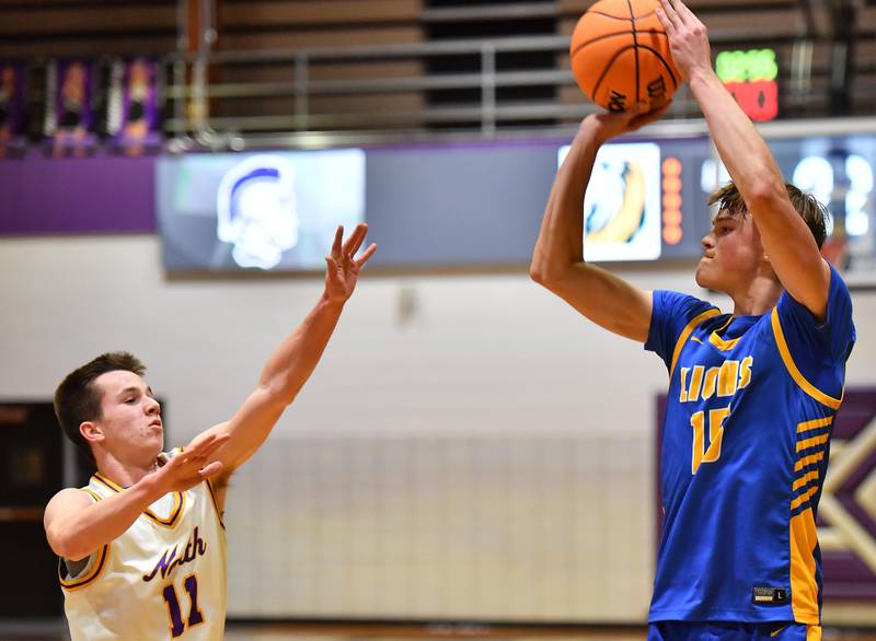 Lyons Township’s Timmy Sloan (right) shoots a three pointer over Downers Grove North’s Connor Crowley (11) during a game on January 15, 2026 at Downers Grove North High School in Downers Grove .