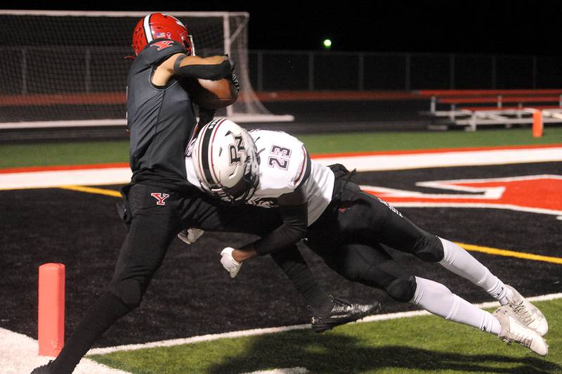 Yorkville receiver Dominick Coronado (left) tries to twist into the endzone but is stopped on the one-yard-line by Plainfield North defender Keith Cyracus (23) during a varsity football game at Yorkville High School on Friday, Oct. 20, 2023.