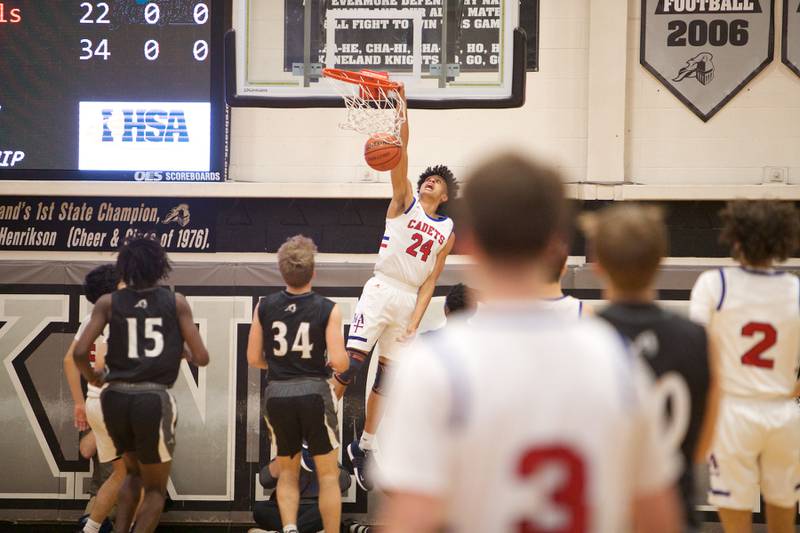 Marmion Academy's Trevon Roots dunks the ball against Kaneland at the Class 3A Regional Final at Kaneland on Saturday, Feb.25, 2023.