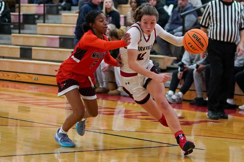 Yorkville's Lainey Gussman (12) drives to the hoop against Minooka's Kendall Thomas (3) during a basketball game at Yorkville High School on Thursday, Dec. 5, 2024.