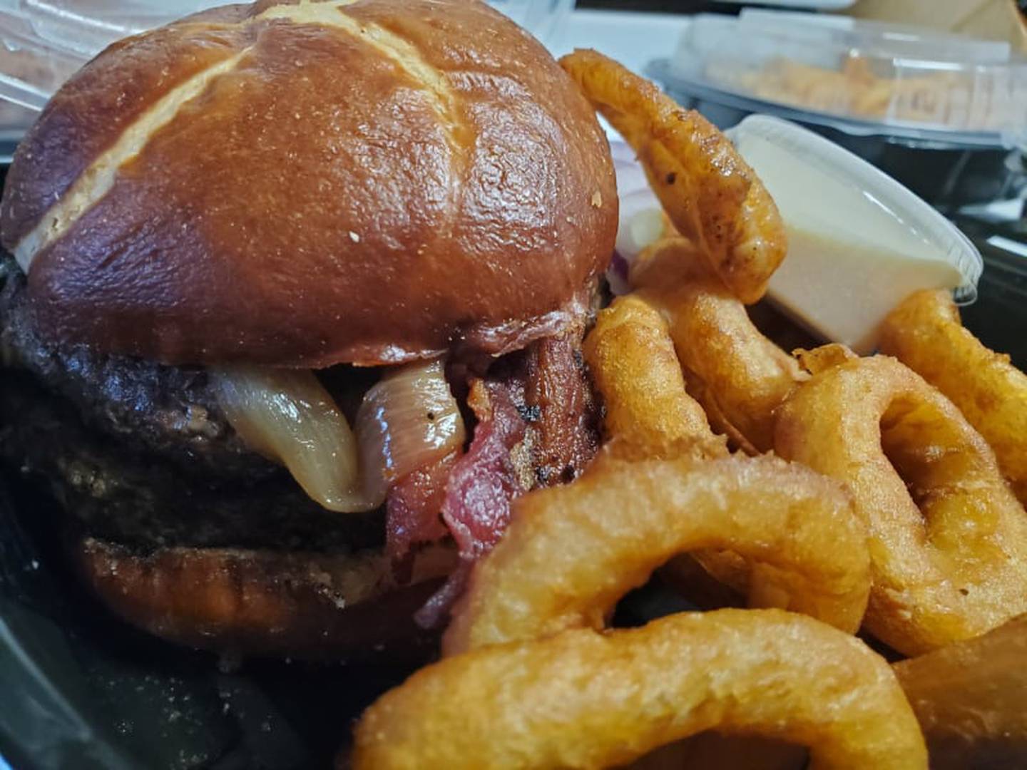 Jameson's Pub offers a Jameson’s Burger with bacon for $26. I ordered medium and it arrived a perfect medium. I swapped the nun for a pretzel bun for $2 which is what I received. I chose onions rings ($2) for the side. The portions were generous (and delicious).