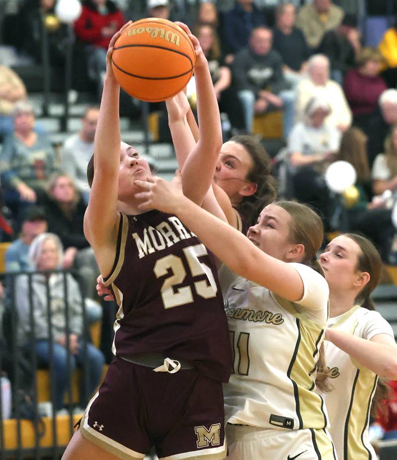 Morris’ Maddie Simpson and Sycamore's Macy Calendo go after a rebound during their game Tuesday, Jan. 13, 2026, at Sycamore High School.