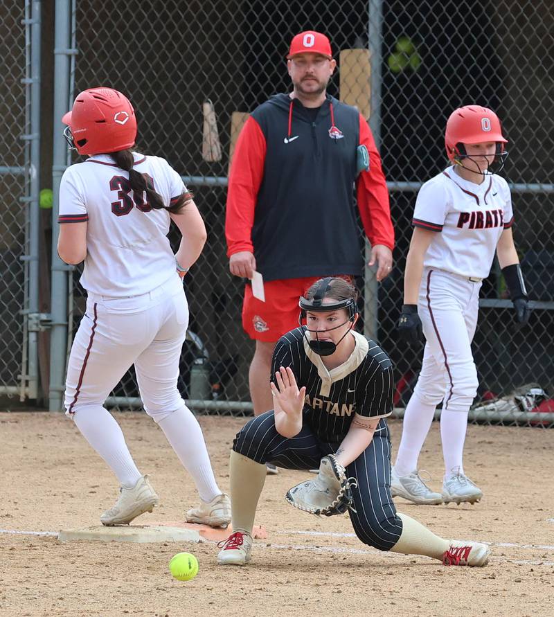 Sycamore's Riley Schuller fields a throw to first as Ottawa's Aubrey Sullivan gets back safely after a caught flyball Friday, April 17, 2026, during thier game at Sycamore High School.