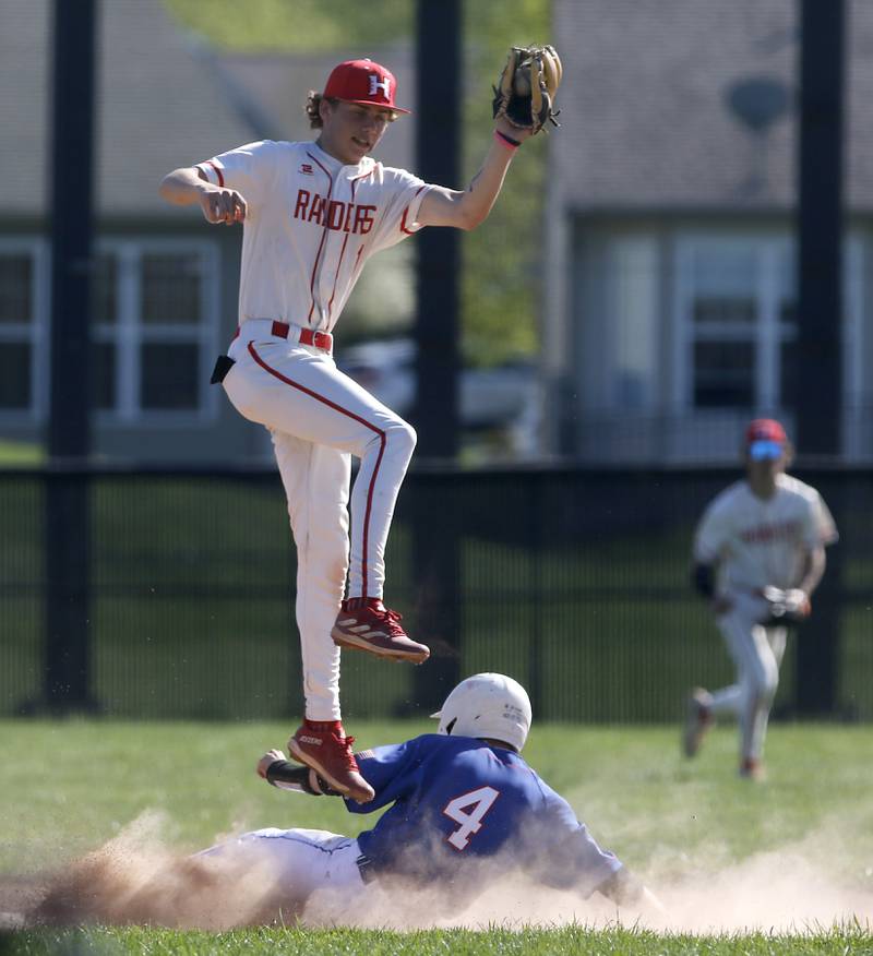 Huntley's Tyler Jakubowski catches a high throw as Dundee-Crown's Ryan Pierce slides into second base during a Fox Valley Conference baseball game on Friday, May 9, 2025, at Huntley High School.