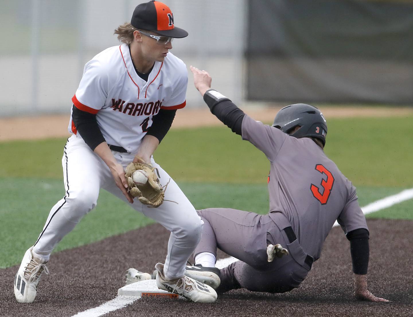 Crystal Lake Central's James Dreher slides into \third base in front of the throw to McHenry’s Kaden Wasniewski during a Fox Valley Conference baseball game on Friday, May 2, 2025, at McHenry High School.