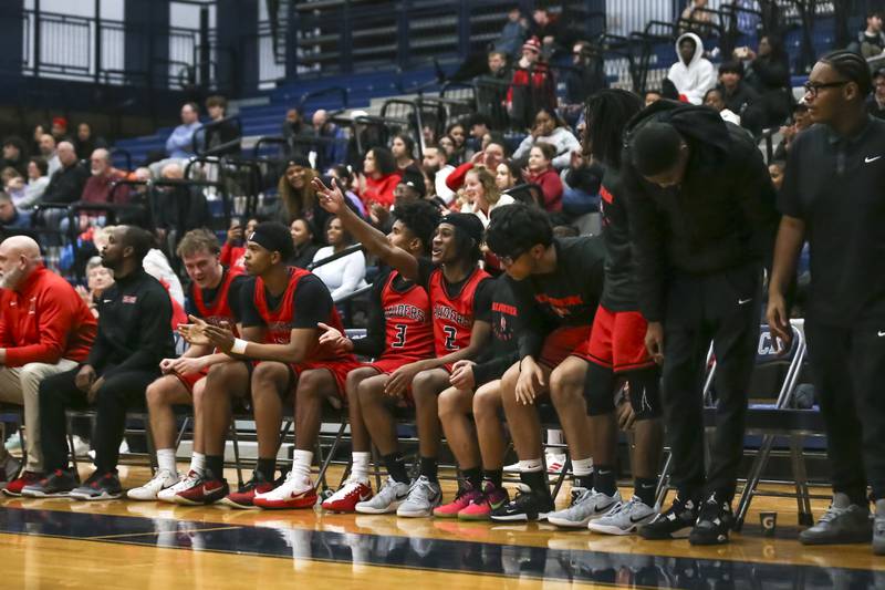 The Bolingbrook bench cheers on the team during their basketball game between Bolingbrook at Oswego East Friday, Jan 30, 2026 in Oswego.