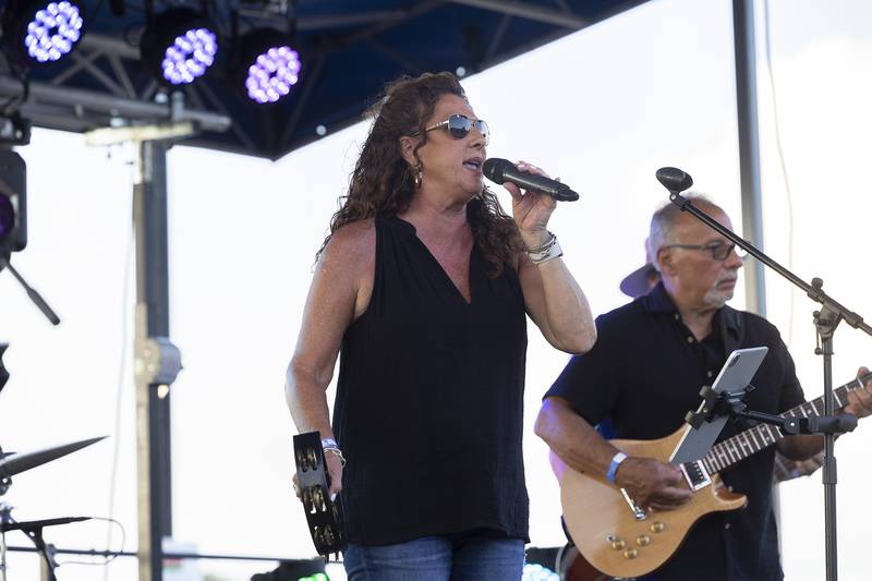 Kim Taylor Welborn, lead singer of the Chicago area band Out of Storage, belts out the hits Thursday, July 3, 2025, at Petunia Fest.