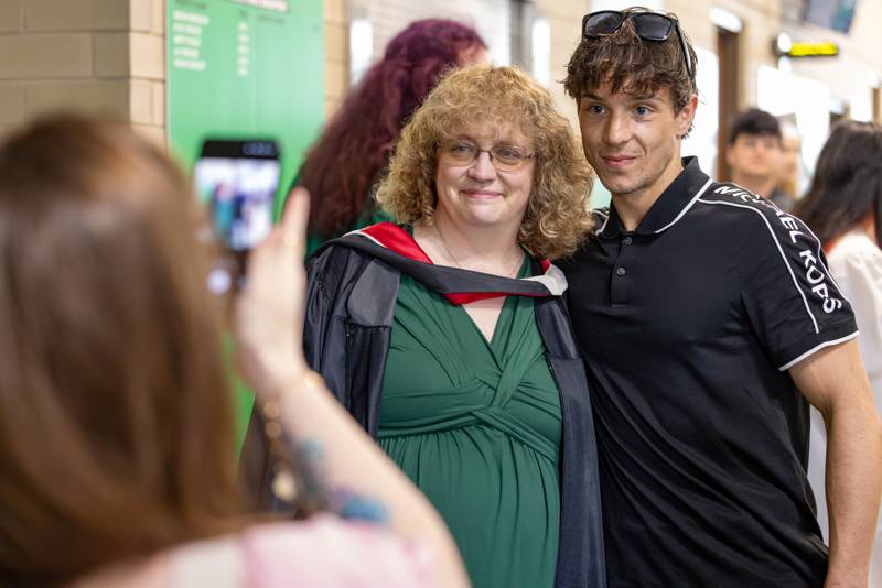 Retiring teach Marilee Applebee takes a photo with a former student who spoke of what an impact that Applebee had on his life at the Seneca High School Class of 2026 Graduation on May 17, 2026 at Seneca High School.