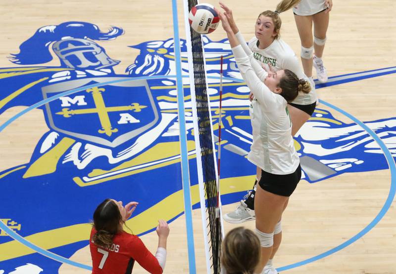 Seneca's Audry McNabb sends a kill past Henry-Senachwine's Lauren Harbison during the Tri-County Conference Championship game on Thursday, Oct. 17, 2024 in Bader Gym at Marquette High School.