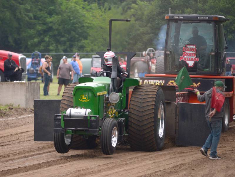 Austin Wright of Paw Paw drives his 410 John Deere aclohol tractor at the Forreston FFA Alumni Tractor and Truck Pull held during Leaf River Daze in Leaf River on Saturday, June 7, 2025.,  He pulled 274.44' in this attempt.
