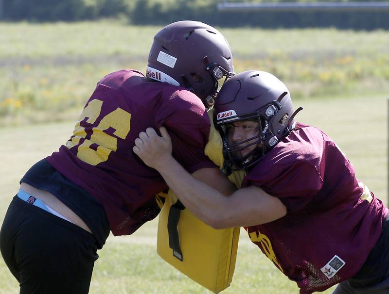 Richmond-Burton’s Jacob Gray, right blocks Ethan Pletcher during summer football practice Thursday, July 14, 2022, at Richmond-Burton High School in Richmond.