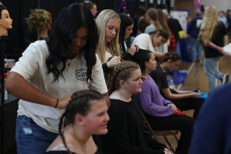Students get their hair done at the Cosmetology table at the Grundy Area Vocational Center 8th grade Career Fair at Morris High School on Tuesday, Oct. 29, 2024 in Morris