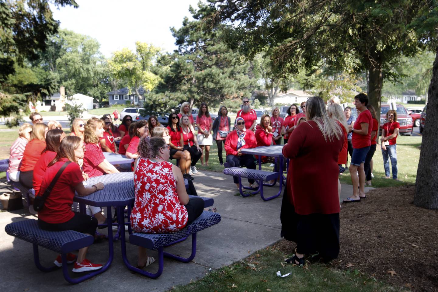 Union president Stephanie Lieurance talks to members of the Crystal Lake District 47 paraprofessional union as they meet outside Lundahl Middle School on Monday, Aug. 28, 2023, for an update on the union's complaint against District 47 for using a staffing agency to fill paraprofessional positions.