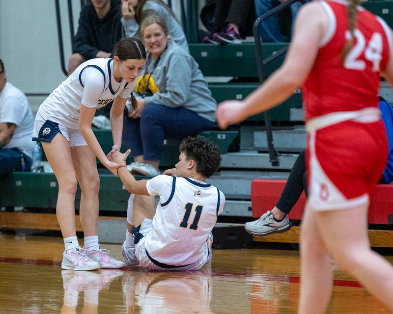 Joslynn James (11) of Sterling is helped up from ground by teammate Brenley Johnson (1) after falling to floor during Regional Championship game on Thursday, Feb. 19, 2026 in Sellett Gymnasium at L-P High School.