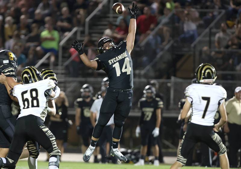 Sycamore's Kiefer Tarnoki nearly blocks a pass attempt by Oak Forest's Luke Sparacino during their game Friday Sept. 2, 2022, at Sycamore High School.