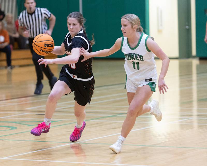 St. Charles East's Kathlyn Bainbridge dribbles the ball against York's Briley O'Brien at the York Girl's Thanksgiving Tournament on Tuesday, Nov. 18,2025 in Elmhurst.