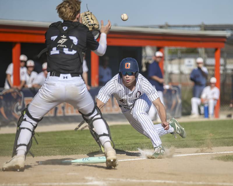 Oswego's Graham Schwab (2) prepares to slide into home during baseball game Oswego East at Oswego.  May 14, 2026 in Oswego.