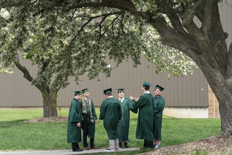 Graduates talk outside of the Crystal Lake South High School before a graduation ceremony for the class of 2022 on Saturday, May 14, 2022, in Crystal Lake.