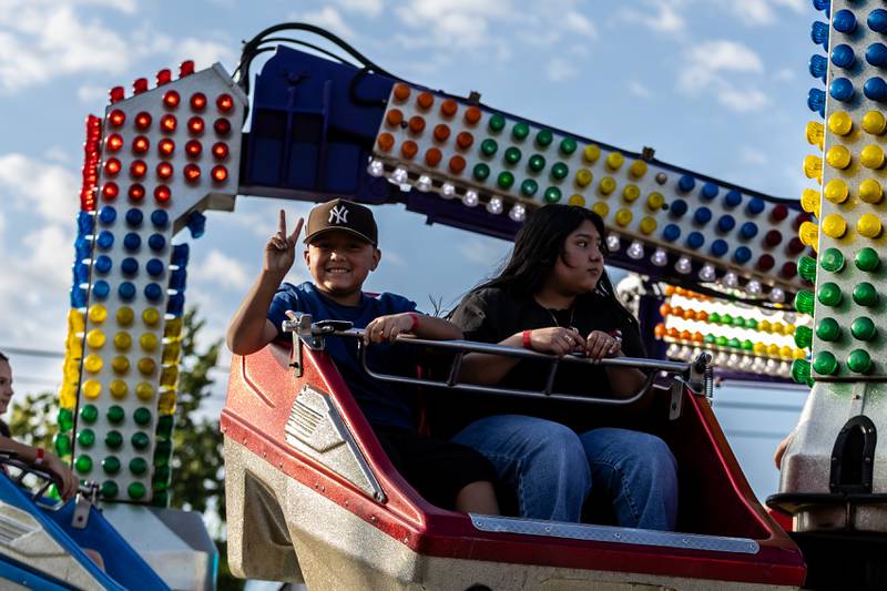 Joliet residents Miguel and Eliza Velazquez ride the Predator during Taste of Joliet on June 20, 2025.