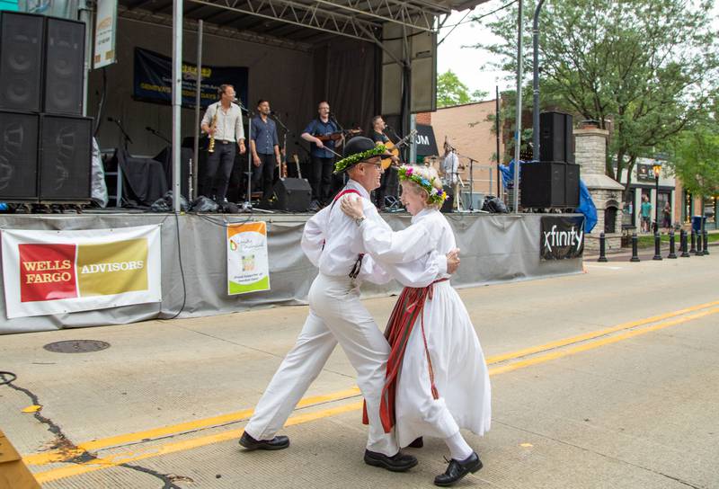 Folkdancers Paul (left) and Linda (right) Muhr of Chicago dance to music performed by the Swedish band Jaerv at Swedish Days on Saturday, June 25, 2022.