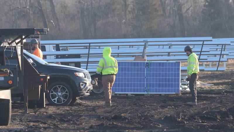 Crews prepare to erect a glass panel on the solar farm located in the 1400 block of North 27th Road (Dee Bennett Road) on Wednesday, Jan. 8, 2026 in Naplate.
