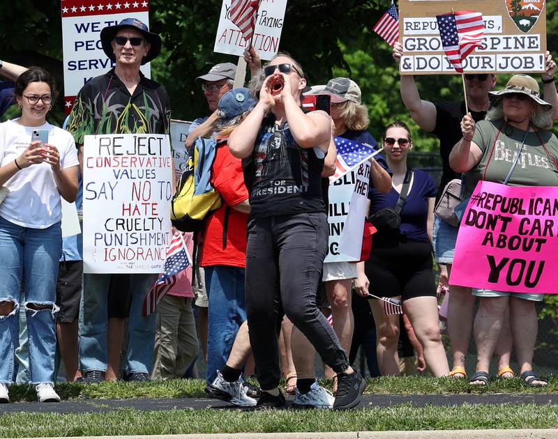 Maddie Boylin, from Genoa, yells at a supporter of President Donald Trump Saturday, June 14, 2025, during a No Kings rally along Sycamore Road at Hopkins Park in DeKalb. The group was protesting the policies of President Donald Trump and his administration.