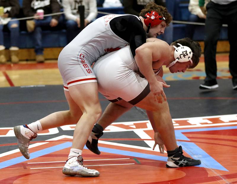 Marian Central's Dan French controls Mt. Carmel's David Ajayi in their 215-pound match during a triangle wrestling meet on Saturday Jan. 11, 2025, between Marian Central, Joliet Catholic, and Mt. Carmel at Marian Central High School in Woodstock.