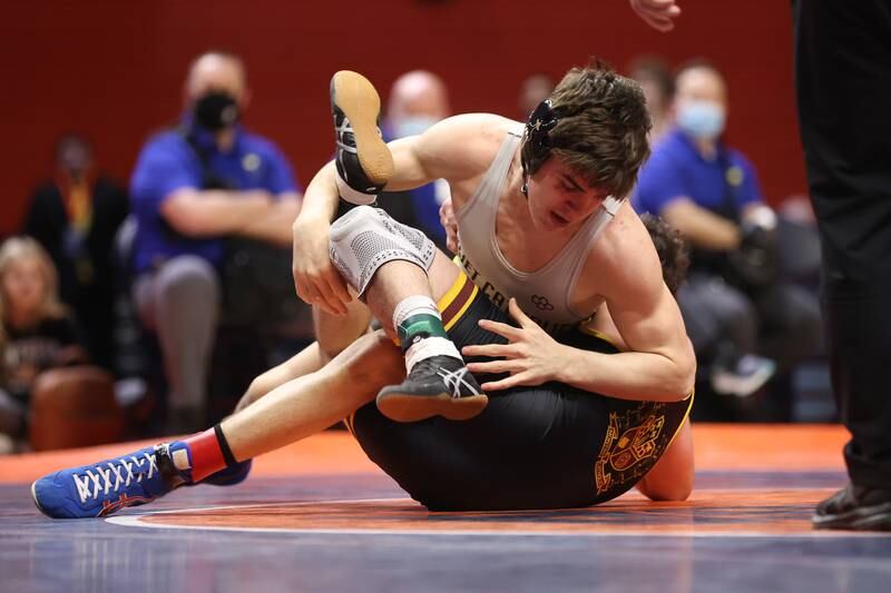 Joliet Catholic’s Mason Alessio works over Montini’s Jayden Colon in the Class 3A 145lb. championship match at State Farm Center in Champaign. Saturday, Feb. 19, 2022, in Champaign.