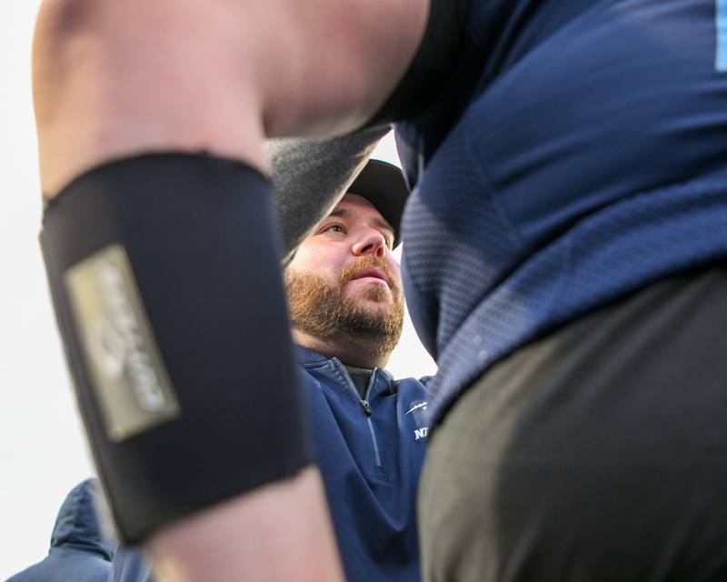 Nazareth Academy running back and linebacker coach Mike Stella talks with Nazareth Academy's William Francis after falling short to Fenwick during the 6A semifinals overtime game on Saturday Nov. 22, 2025, held at Nazareth Academy High School in La Grange Park.