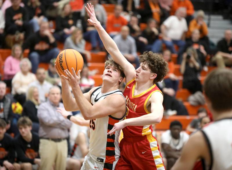Wheaton Warrenville South's Brady Goken attempts a shot under Batavia's Darian Susic during a game on Friday, Feb. 14, 2025 in Wheaton.
