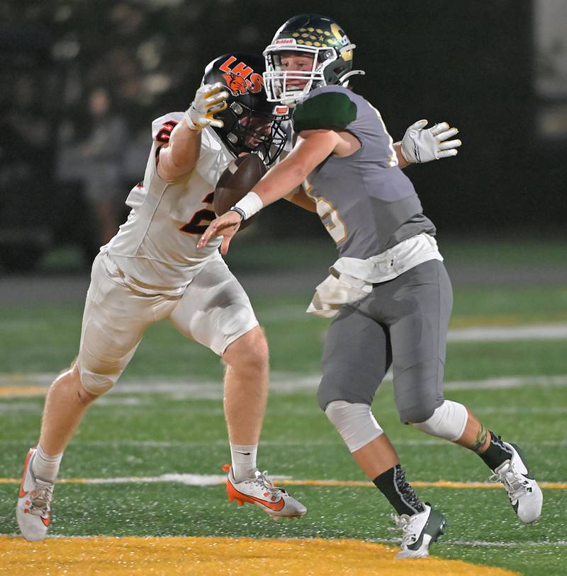 Stevenson quarterback Aidan Crawley is sacked by Libertyville’s Caleb Baczek in a football game in Lincolnshire on Friday, Sept. 13, 2024.