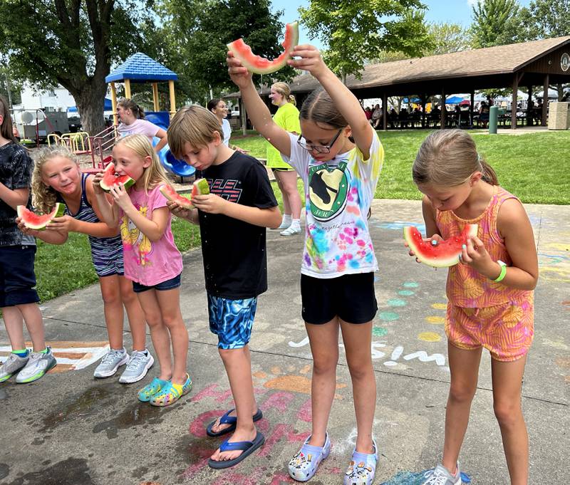 Kennlee Sieber, 9, of Forreston, holds her watermelon rind high as she wins her age division at Forreston's Sauerkraut Days' Watermelon Eating Contest on Saturday, Aug. 3, 2024. Winners of each age division were awarded a medal and a can of Frank's Sauerkraut.
