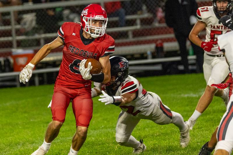 Braden Curran (8) of Hall runs ball with Erie-Prophetstown defense on hip on Friday, Sept 5, 2025 at Richard Nesti Stadium in Spring Valley.
