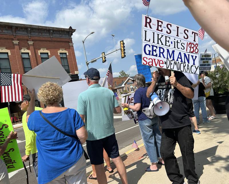 An attendee at the "No Kings" rally held in Oregon, Illinois on Saturday, June 14, 2025 carries his sign critical of the actions by President Donald Trump.