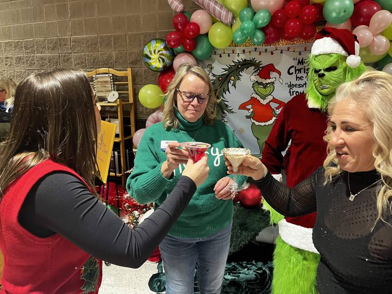 Chain O' Lakes chamber Executive Director Therese Matthys, center, shares a toast with (from left) Stephanie Grams of the Volo Museum and Kim Bromberek of Countryside Banquets as the Grinch looks on at the inaugural Mistletoe & Martinis in 2024. This year's event is Nov. 28.