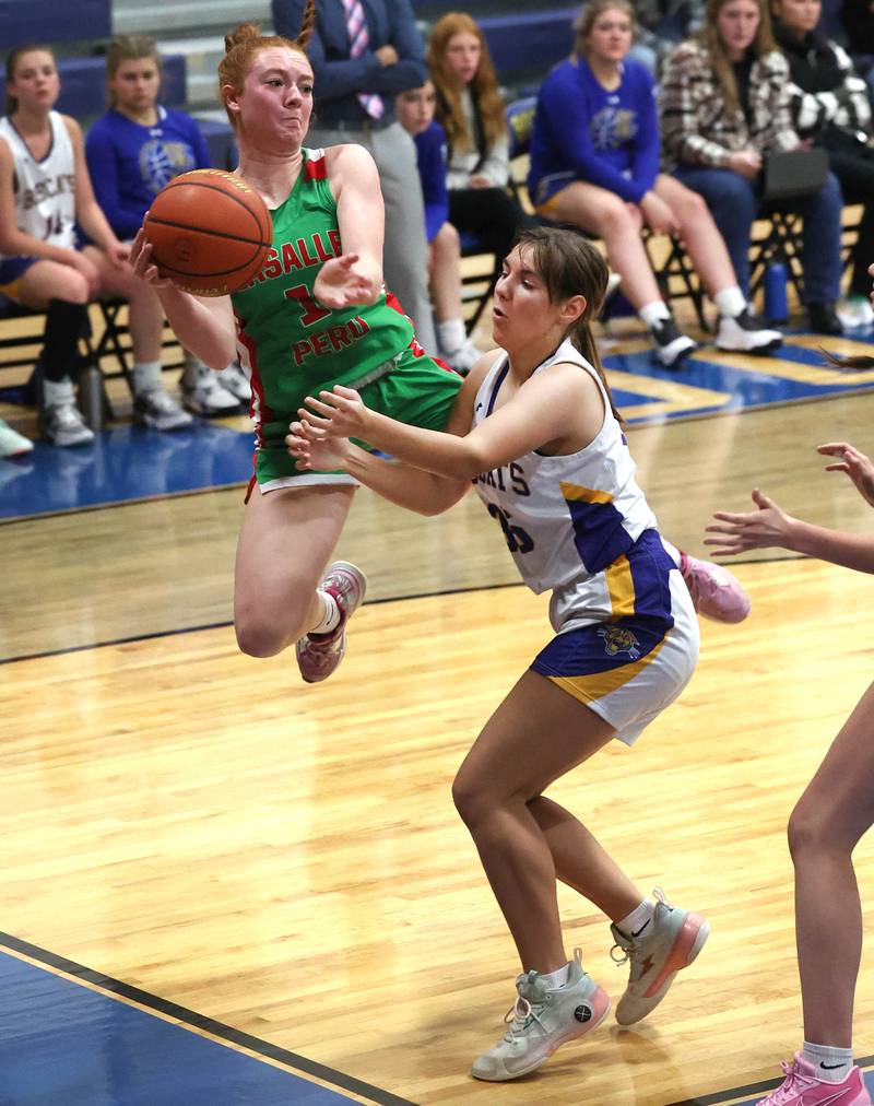 LaSalle-Peru's Addie Duttlinger saves the ball from going out-of-bounds as Somonauk's Kennedy Barshinger plays defense during their game Thursday, Nov. 16, 2023, in the Tim Humes Breakout girls basketball tournament at Somonauk High School.