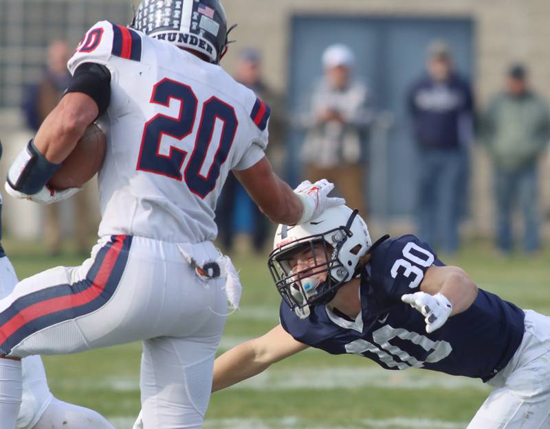 Cary-Grove’s Landon Moore dives in to tackle Belvidere North’s Erick Roman in IHSA Class 6A quarterfinal playoff football action on Saturday, Nov. 16, 2024, at Al Bohrer Field on the campus of Cary-Grove High School in Cary.