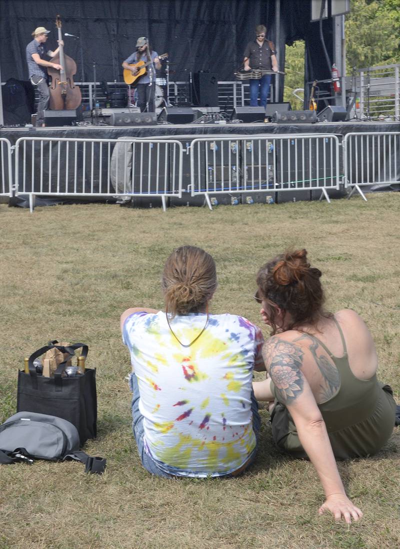 This couple enjoy their wind and the sounds of Caleb Caudle and the Sweet Critters during the Vintage Wine Festival Saturday at Carey Memorial Park in Utica.