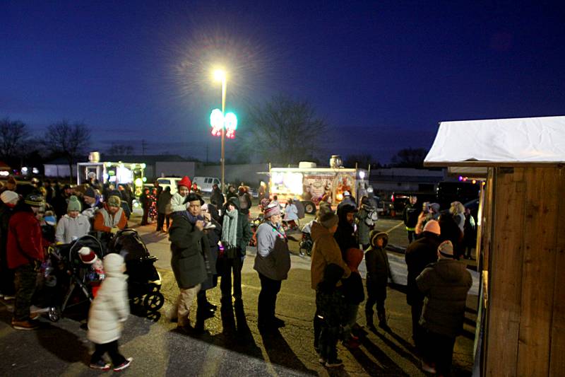 People line up for hot chocolate as part of holiday events Saturday, Dec. 7, 2024 in downtown Marengo.