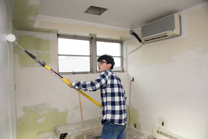 Rock Falls High School building trades student Marion Alvarado works under the instruction of teacher Matthew Hicks on the ROE project in Sterling.