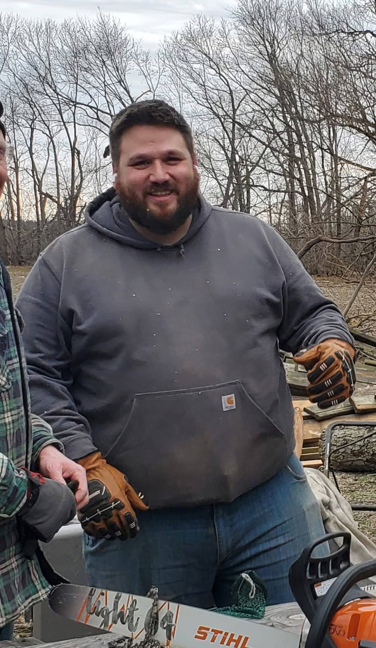 Sean Curbow smiles while helping with cleanup following the March 10 tornado that devastated parts of Kankakee County.