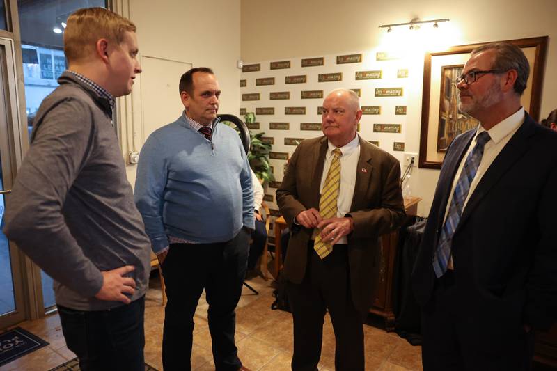 Tom Demmer, State Representative and candidate for State Treasurer, left, Will County Judge Daniel Rippy, Defense attorney Jeff Tomczak and Bob Bodach, candidate for Will County Circuit Court Judge, talk at the GOP event at Its Amazing in Joliet on Monday.