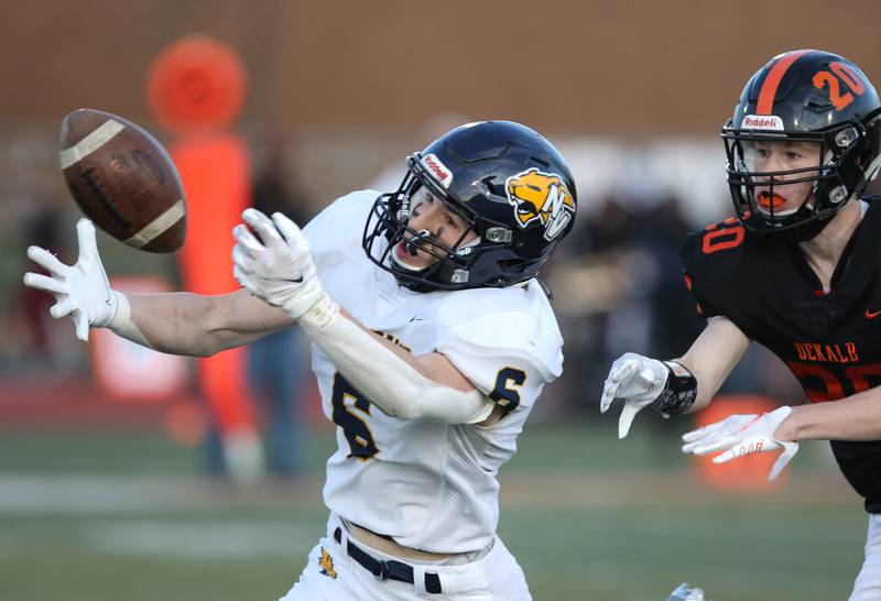 Neuqua Valley receiver stretches for a pass just out of his reach as he gets behind DeKalb's Michael Robinson during their game Friday night at DeKalb High School.