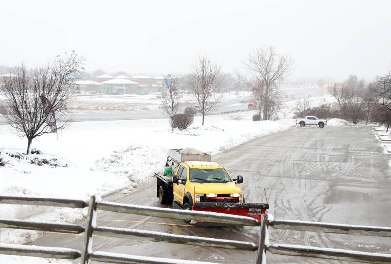 A snow plow clears the parking lot of the Emagine movie theater in Batavia after an overnight snowfall on Tuesday, Jan. 9, 2024.
