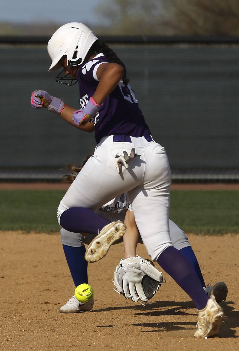 Hampshire's Julissa Akins avoided the ball as Burlington Central's Kelsey Covey tries to field the ground ball during a Fox Valley Conference softball game on Tuesday, April 21, 2026, at Hampshire High School.