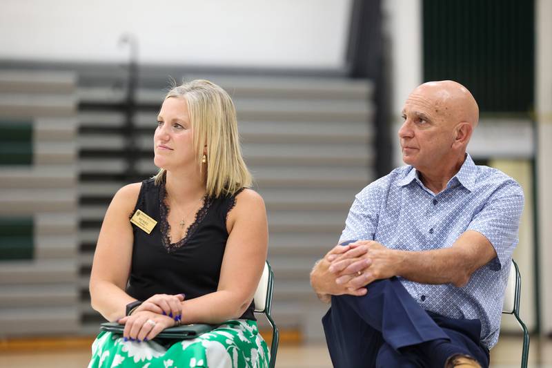 Bishop McNamara principal Kaelyn Bess, left, and former principal Terry Granger listen as longtime coach Rich Zinanni speaks during the ribbon-cutting ceremony for the new Rich Zinanni Athletic Complex on Thursday, Aug. 21, 2025.